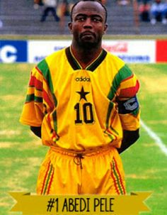 a man standing on top of a soccer field wearing yellow and green uniforms with numbers