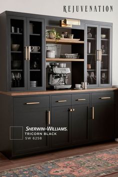 a large black cabinet with glass doors and gold trimmings on the bottom shelf