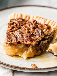 a piece of pecan pie sitting on top of a plate next to a banana