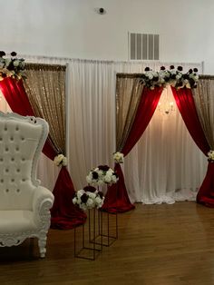 the chairs are decorated with flowers and red drapes for an elegant touch to the room