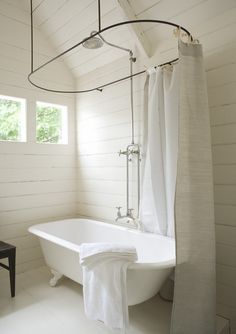 a white bath tub sitting inside of a bathroom