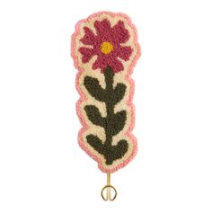 a pink and black flower on a hook