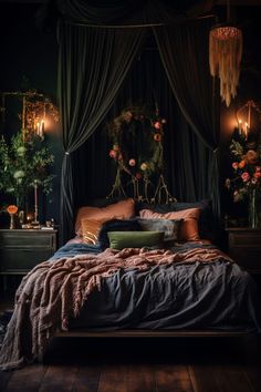 a bed with pillows and blankets in a dark room next to two lamps on either side of the bed