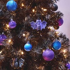 a decorated christmas tree with purple and blue ornaments