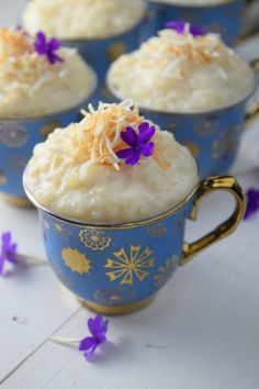 coconut tress leches rice pudding in blue cups with purple flowers on the rim