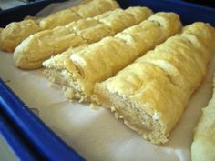 several pastries are lined up on a blue tray