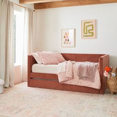 a living room with a couch, rug and pictures hanging on the wall above it