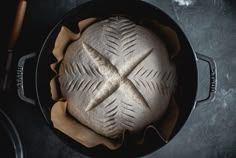 a loaf of bread sitting in a pot on top of a table