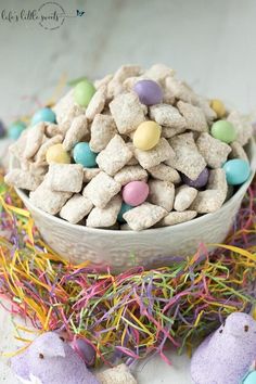 a bowl filled with easter treats on top of a table