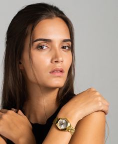 A classic design, elevated. The bold and urban Vivid watch features a statement round face with chunky outer casing that’s juxtaposed by the delicate sunray dial, minimalist numerals and crystal detailing. In elegant yet eccentric gold, silver and white with a 32mm face, Vivid is a powerful piece pairing androgynous design with robust links made of gold-plated stainless steel for effortless sophistication. Chic Gold Watches For Work, Chic Gold Everyday Watch, Chic Everyday Gold Watches, Modern Gold Watches For Work, Modern Gold Watch For Work, Chic Gold Watch With Metal Dial, Minimalist Gold Watches For Work, Minimalist Gold Watches Suitable For Work, Gold Watch With Metal Dial For Work