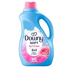 a bottle of downy soft laundry liquid with pink flowers on it and the lid is open