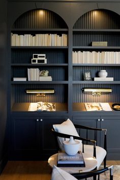 a living room filled with furniture and bookshelves covered in shelves full of books