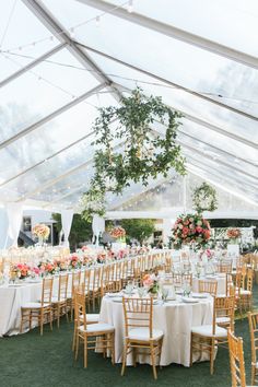 an outdoor tent with tables and chairs set up