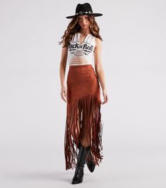 Channel your western side with this trendy-chic skirt that will level up your festival look! It features a high-rise waist, an asymmetric mini-length hem with a form-hugging fit, and long fringe detailing that cascades to your ankles. The stylish fringe design will dance with you to your favorite band! Complete your 'fit with a cropped graphic tee and cowboy boots.Fit & FeaturesHigh-rise waistBack zipper, hook and eye closureAsymmetric mini-length hemForm-hugging fitLong fringe design, ankle Fringe Outfits Western, Fringe Skirt Concert Outfit, Long Fringe Skirt Outfit, Western Fringe Skirt Outfit, Long Skirt With Tshirt, Western Skirt Outfits, Long Fringe Skirt, Boho Skirt Outfit, Fringe Skirt Outfit