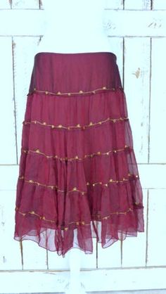 "Vintage sheer silk dark red ruffle midi skirt/mid length tiered festival skirt/90s burgundy/maroon silk skirt/large Features... -sheer 100% overlay -accented with metallic gold threading -stretch poly lining -midi length -zipper side -90's vintage Measurements...taken flat -marked size: large -across waist: 18\" -length: 29\" Condition... -excellent vintage condition -minimal wear UJ2065" Fall Tiered Ruffled Skirt, Festive Ruffled Tiered Skirt Dresses, Festive Tiered Ruffled Skirt Dresses, Elegant Tiered Summer Skirt, Festive Elegant Ruffled Skirt, Fitted Tiered Skirt Dress For Festivals, Fitted Flared Skirt For Festivals, Bohemian Full Skirt Bottoms For Party, Bohemian Fall Party Skirt