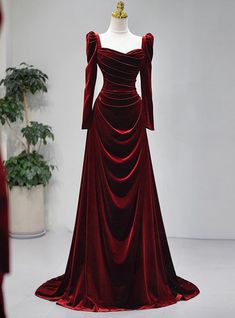 Helmed as the pinnacle of eveningwear elegance, this prom dress commands attention with its sumptuous velvet and regal burgundy shade. The carefully draped bodice pairs with a snug waist to celebrate the figure, while the full-length sleeves and off-the-shoulder neckline lend a dramatic flair. Designed to cascade to the floor in a perfect balance of poise and comfort, the dress finishes with a train that speaks to traditional bridal inspirations, reimagined for a modern prom night of dancing under the stars. Elegant Dresses Long Sleeve, डिजाइनर कपड़े, Formal Wedding Party, Hot Prom Dress, Winter Wedding Guest Dress, Elegant Wine, Velvet Prom Dress, Long Sleeve Dress Formal, Burgundy Prom Dress