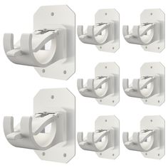 six white wall mounted toilet paper dispensers with handles and clips on each side