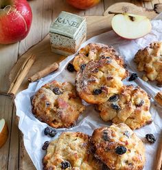 baked goods displayed on wooden tray with apples and cinnamon sticks