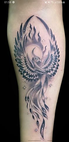 a woman's thigh with an artistic tattoo design on her leg and the image of a bird