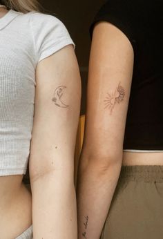 two women with matching tattoos on their arms