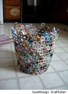 a trash can made out of magazines on the floor