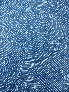 an abstract blue background with white swirls and dots in the shape of wavy lines