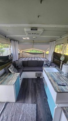 the inside of an rv with couches, tables and other items in it's interior