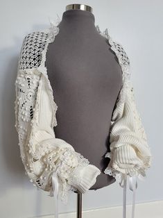 One of a kind upcycled patchwork bolero jacket handcrafted from a circa 1950s crochet blanket, vintage crochet table runner and preloved sweater. Adorned with ribbons and lace. The shoulder has elastic to help preventing the jacket from sliding off the shoulders. Cuffs can be unrolled to fit longer arms. 100% off-white/ivory cotton.  White trims, new material. Doing my part to help save our planet. 10% of all sales will be donated to Greenpeace. Crochet Garments Free Patterns, Boho Upcycled Clothing, Bolero Jacket Outfit, Upcycle Crochet, 1950s Crochet, Jacket Upcycle, Crochet Materials, Bolero Crochet, Vintage Bridesmaid Dresses