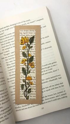 an open book with yellow flowers on it