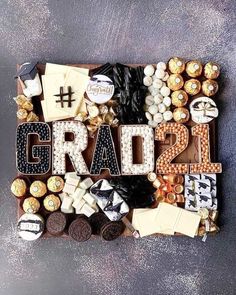 the word grad spelled out in letters surrounded by chocolates and candies