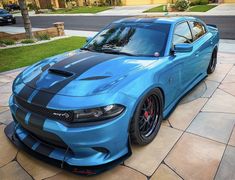 a blue sports car parked in front of a house