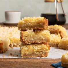 four pieces of coconut bars stacked on top of each other