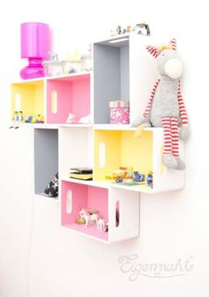 a stuffed animal sitting on top of a shelf