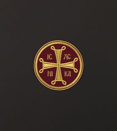 a gold and red cross on a black background