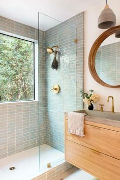 a bathroom with a sink, mirror and shower