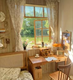 a bedroom with a bed, desk and chair in it next to a large window