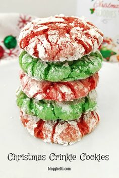 a stack of cookies covered in powdered sugar on top of a white plate next to a christmas card