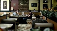 two people sitting at tables in a restaurant