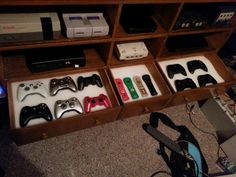 several different video game controllers in a wooden box