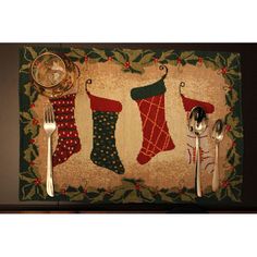 a place mat with christmas stockings and silverware on it