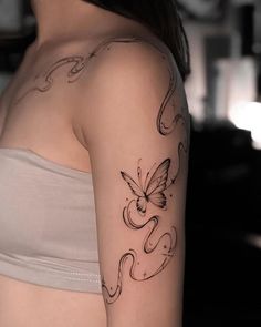 a woman with a butterfly tattoo on her arm