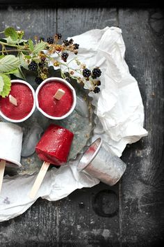 some food is sitting on a plate with toothpicks and berries next to it