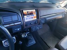 the interior of a car with dashboard controls