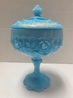 a blue glass bowl sitting on top of a table