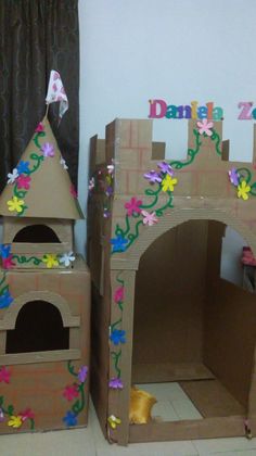 two cardboard castles with flowers and vines on them