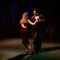 a man and woman are dancing on stage