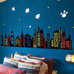 a bedroom with a city skyline painted on the wall