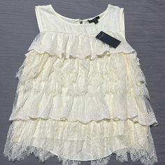 Nwt Size Small, Cream / Beige Ruffle Tiered With Lace Shirt White Ruffled Tank Top For Spring, Chic Summer Lace Top For Layering, Chic Lace Top For Summer Layering, Casual White Tiered Top, White Tiered Casual Tops, Summer Ruffles Tank Top, Sleeveless Ruffled Blouse For Daywear, Summer Sleeveless Lace Top With Ruffles, Chic Ruffled Tank Top