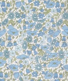 a blue and green flowered wallpaper with small flowers on it's side