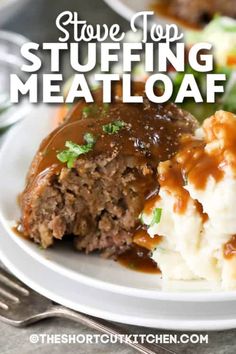 a white plate topped with meatloaf covered in gravy and mashed potatoes